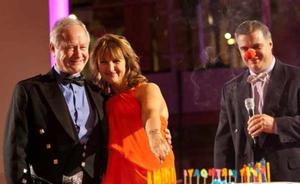 tna co-founder Alf Taylor (left) blows the candles out on the company's 30th anniversary celebration cake.